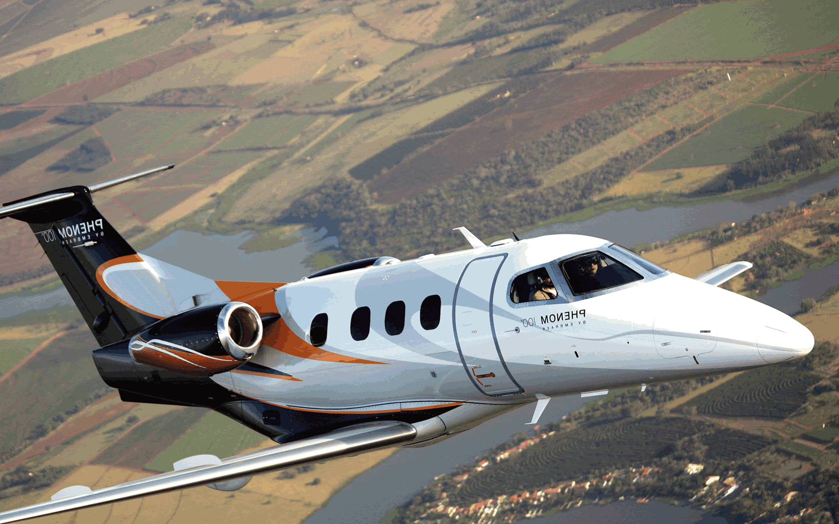 1680x1050 Charter Phenom 100 private jet from €790 per flying hour Wallpaper