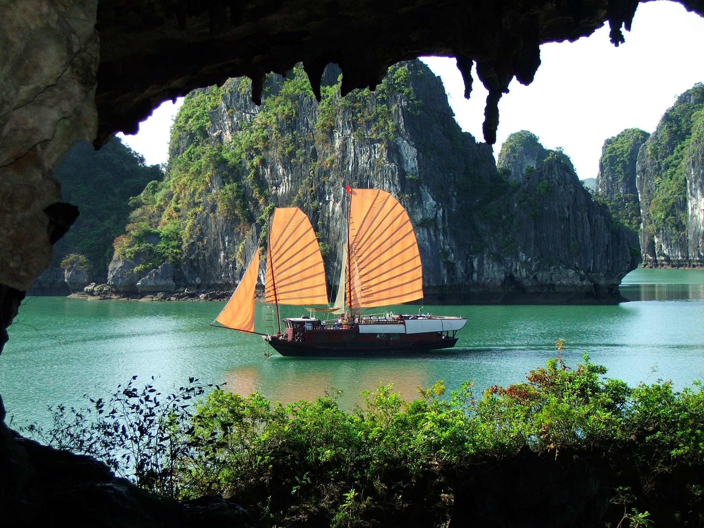 Cruise boat on calm waters of Ha Long Bay in September