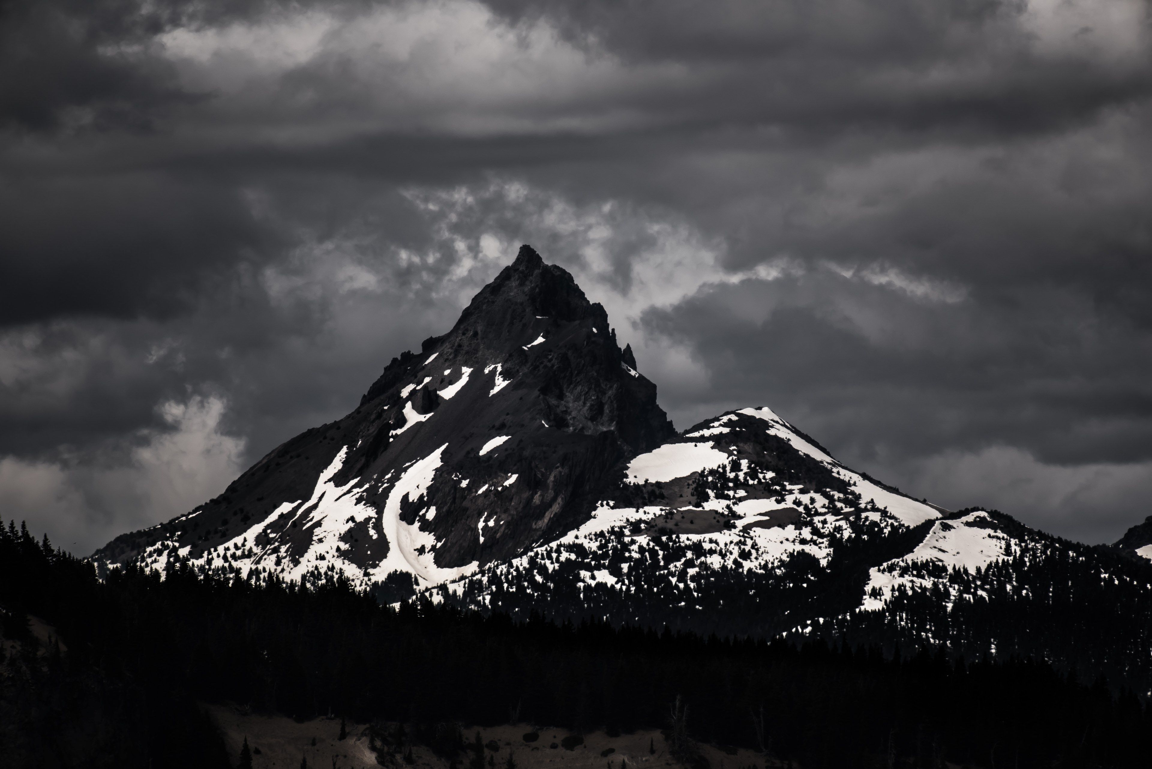 3840x2563 a desaturated shot of a dark mountain covered in patches of white ... Wallpaper