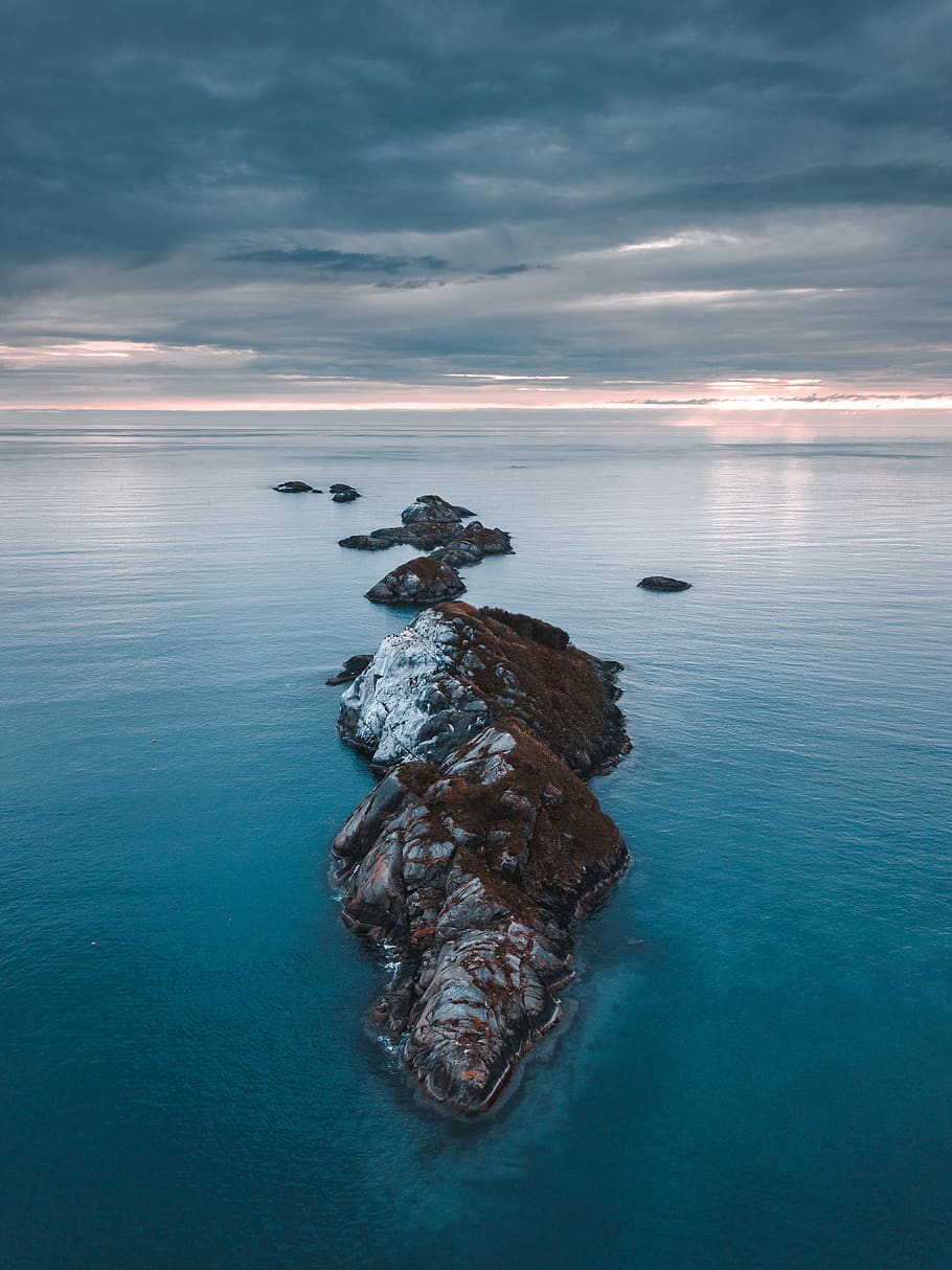 910x1214 HD wallpaper: Brown Island, beach, clouds, dramatic sky, drone ... Wallpaper